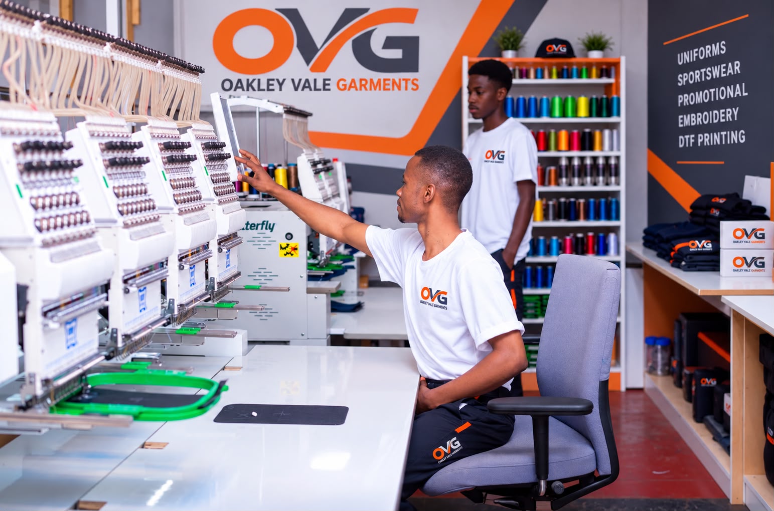 Team member operating the embroidery machine
