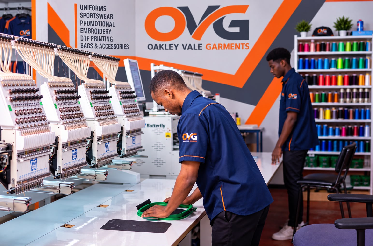 Oakley Vale Garments team preparing a garment at the embroidery machines